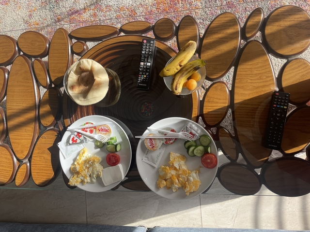       Table set with a breakfast meal including eggs, vegetables, and fruits.
  