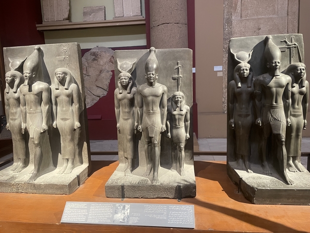       Ancient statues of Egyptian figures on display in a museum.
  