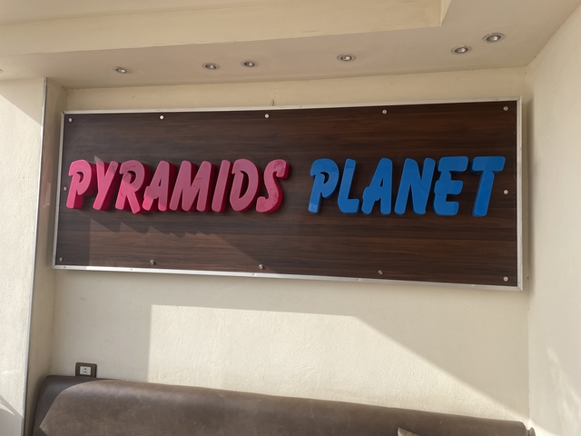       Signboard with 'Pyramids Planet' text on it.
  