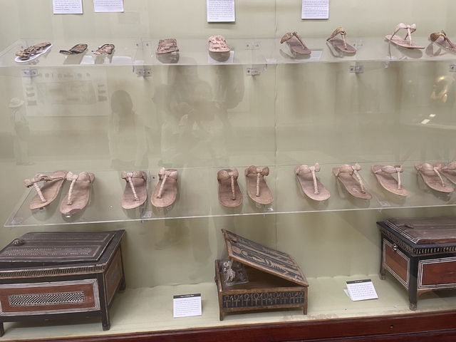       Display of traditional Egyptian sandals in a museum setting.
  
