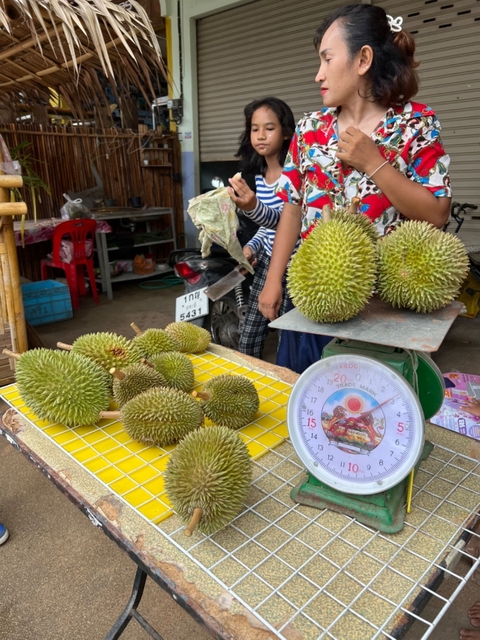 Market vendor selling durians.