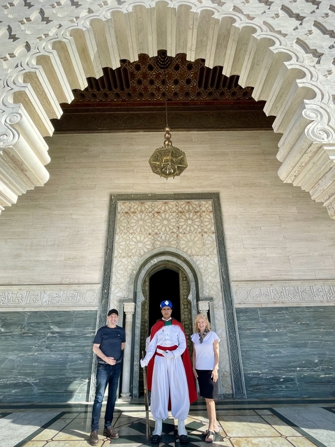       Man standing at a decorative entrance with archway
  