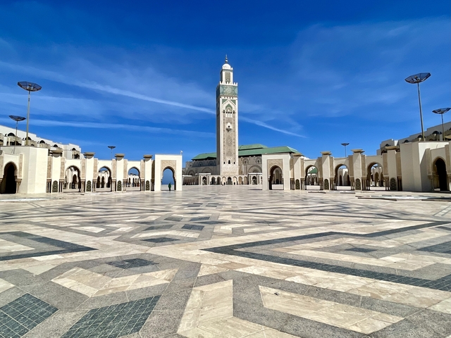       Grand mosque exterior with geometric patterns.
  