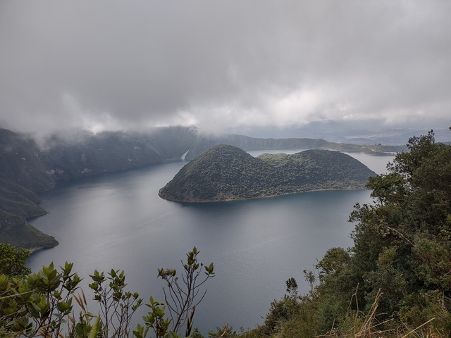Scenic view of a lake with an island covered in greenery.