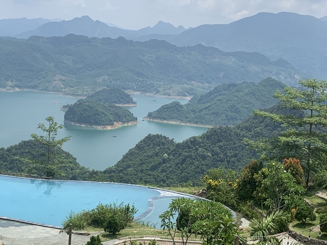 A scenic view of hills and a blue lake
