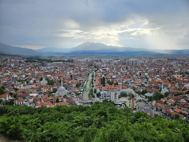 Aerial view of a city with mountainous backdrop
