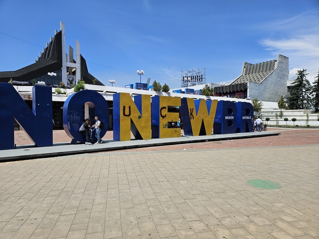 Large sign with prominent letters in a public square