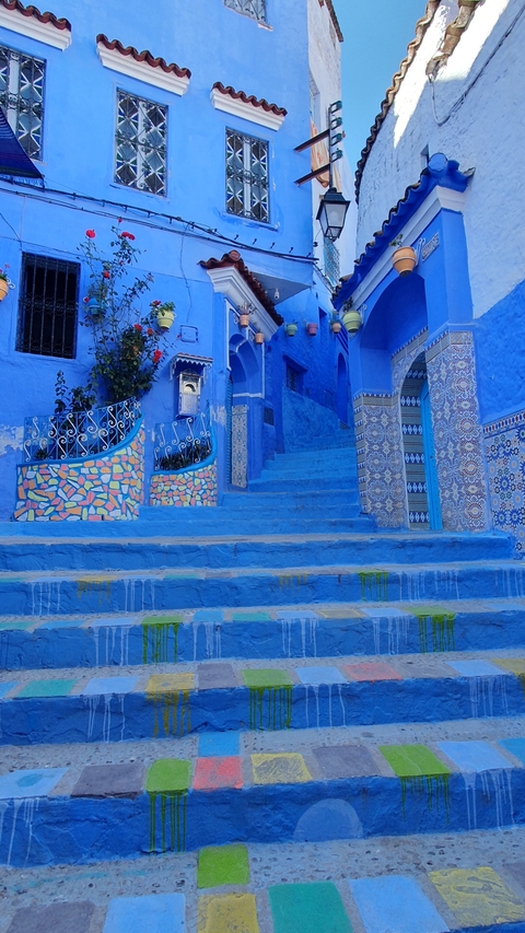       Blue-painted steps and walls with intricate designs.
  