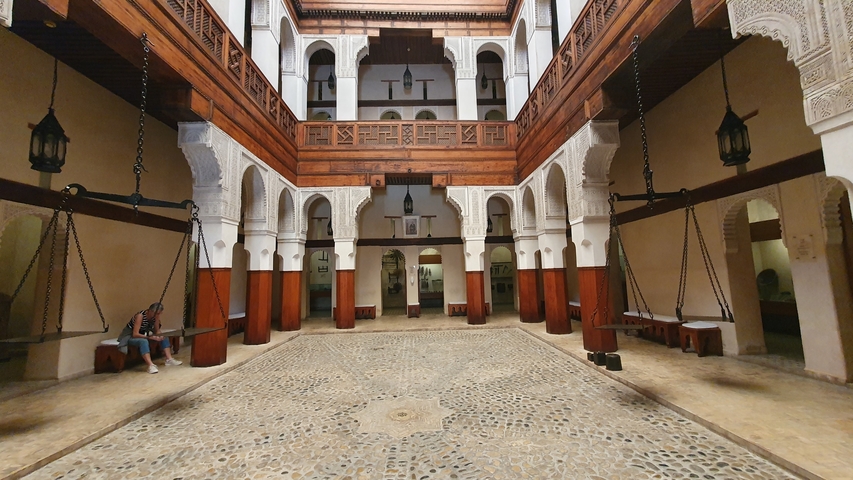       Traditional interior with patterned tiles and hanging lamps.
  