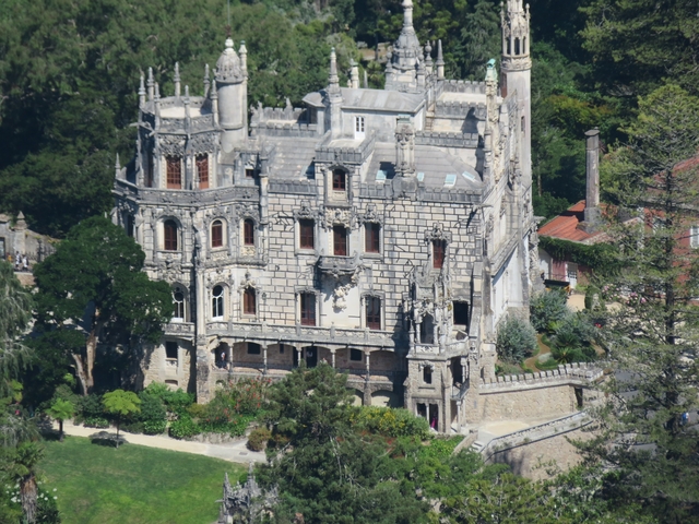       Ornate historic building with greenery.
  