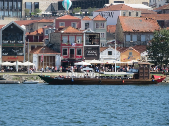       Busy waterfront area with boats and colorful buildings.
  