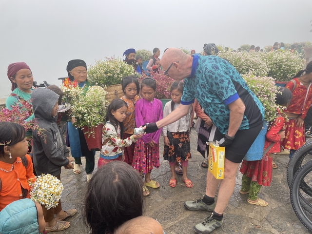 Group of people interacting at a flower market.
