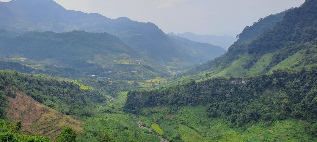Panoramic view of a lush green mountain valley.
