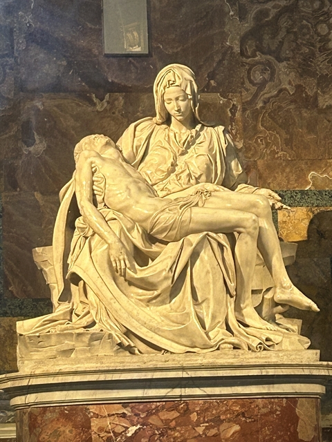       A marble statue of a draped figure embracing another figure.
  