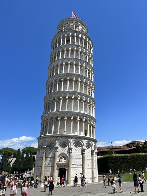       A segment of the Leaning Tower of Pisa against a blue sky.
  