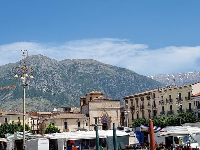 Town square with a church and mountains in the background