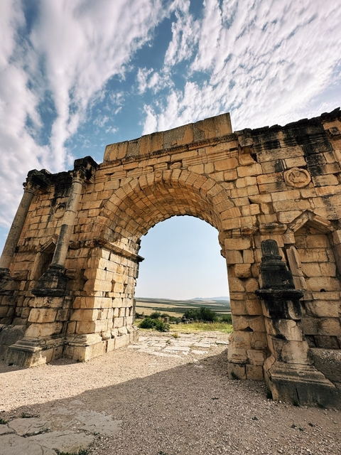 Ancient stone arch with a landscape view