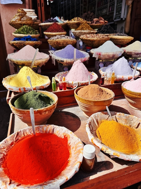       Colorful spice powders on display in bowls
  