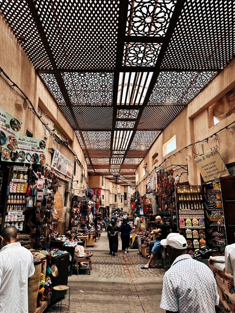       Covered market street with various goods on display
  