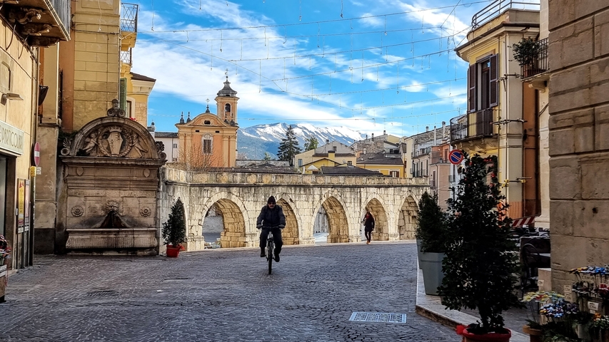       Historic town square with an arched structure
  