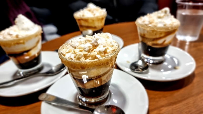 Desserts served in glasses topped with cream