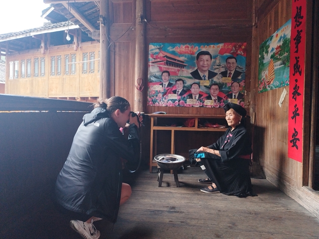 Photographer capturing an elderly woman in a traditional home