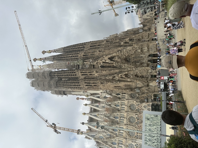 People visiting a famous Catholic basilica under construction.