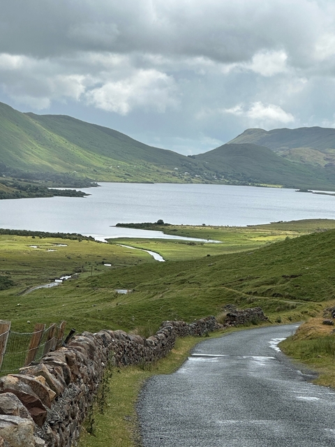 Vast lake surrounded by green hills.
