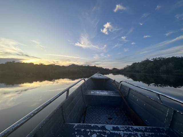 Calm river journey with a view from a boat at sunset.