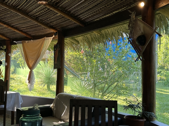 Interior view of a cabin with views of a lush green garden.