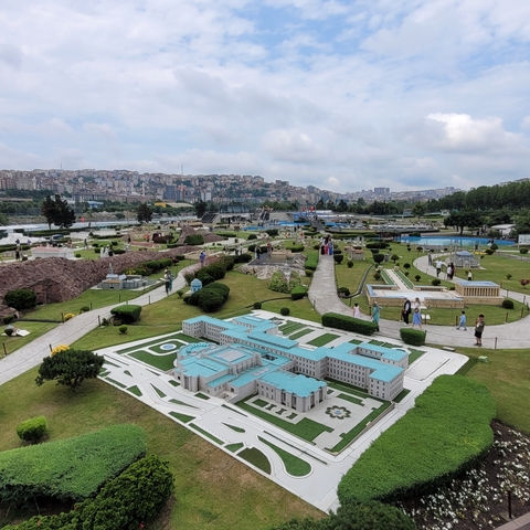       Miniature scale models of buildings in a park setting.
  