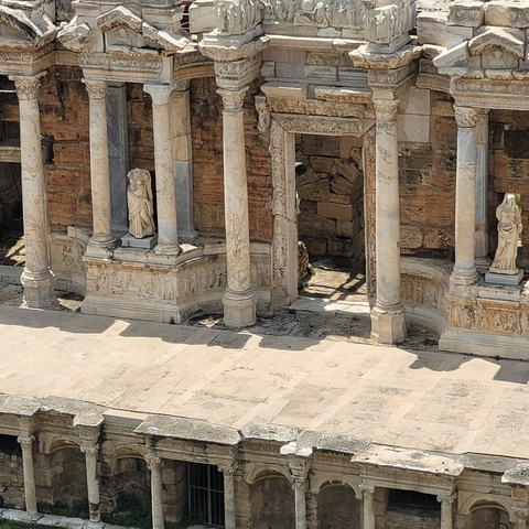       Ancient amphitheater with preserved stone columns.
  