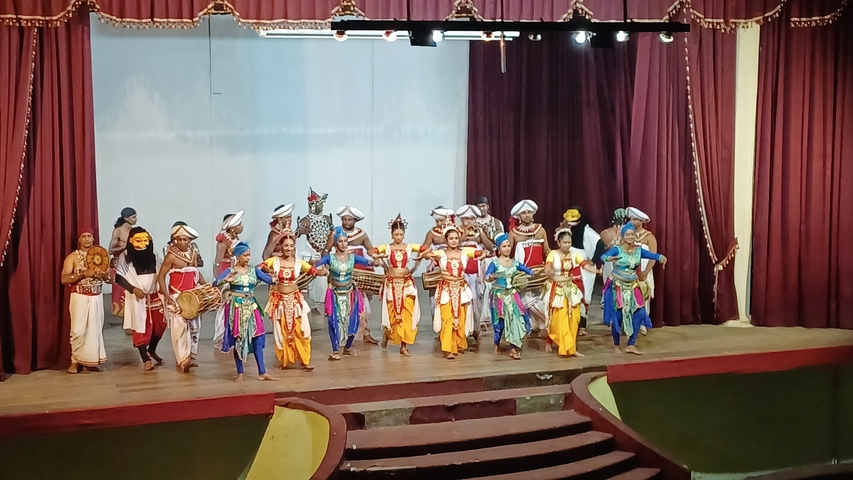 Traditional dance performance with colorful costumes on stage.