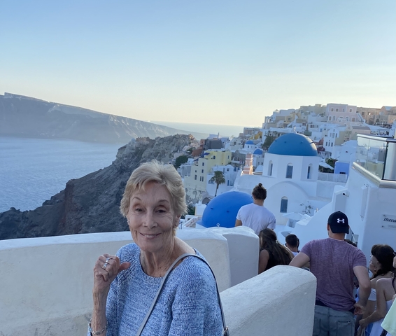 Person posing in Santorini with blue domes