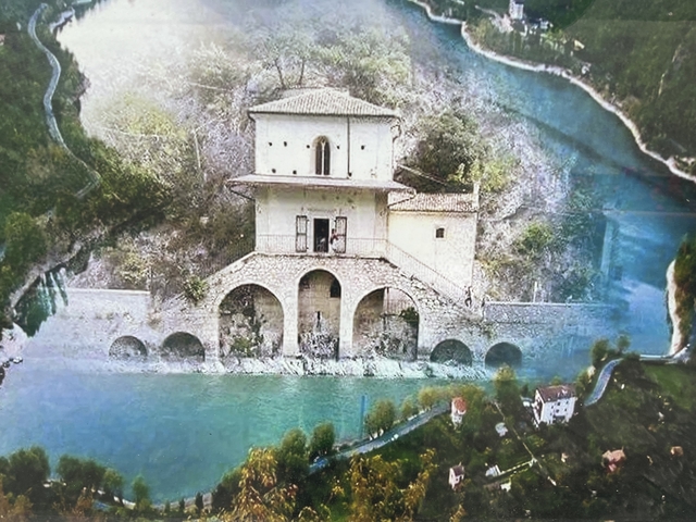 Scenic view of a house by a river.
