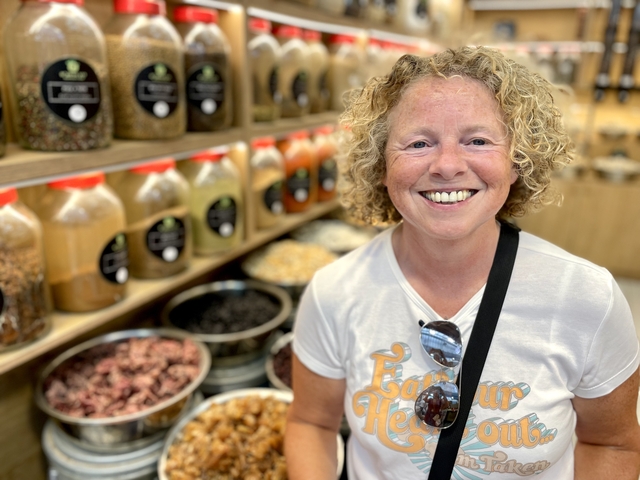 Woman smiling in a spice market.