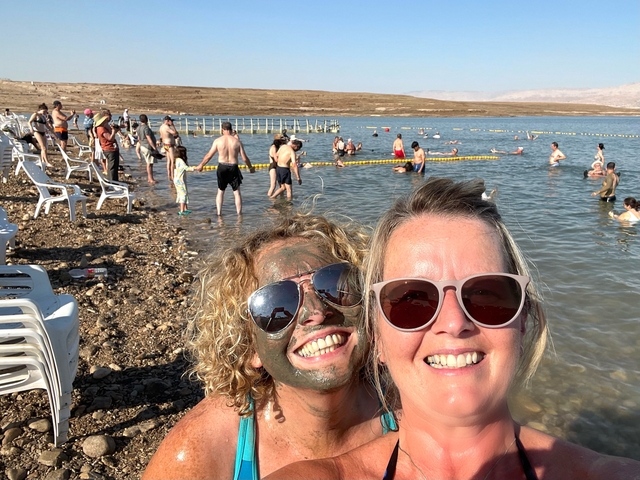       People enjoying a mud bath at the Dead Sea.
  