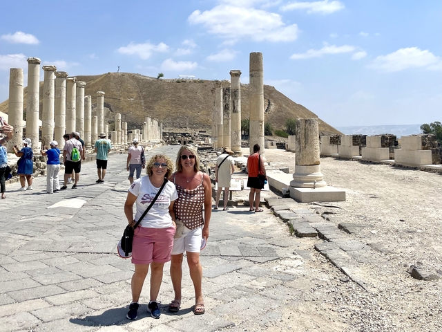 People standing among ancient ruins.