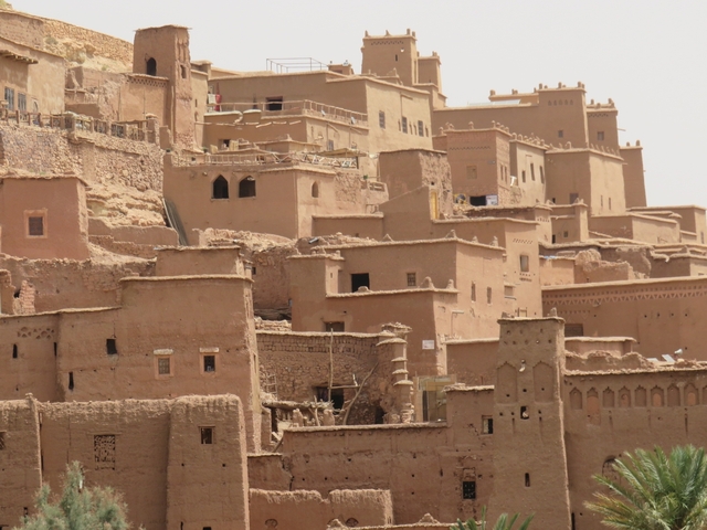 Mud-brick structures built into the hillside with an earthy tone.