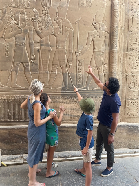       Family looking at ancient Egyptian wall carvings.
  