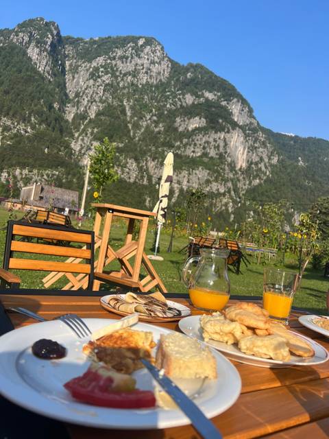 Breakfast on a table with an outdoor mountain view.