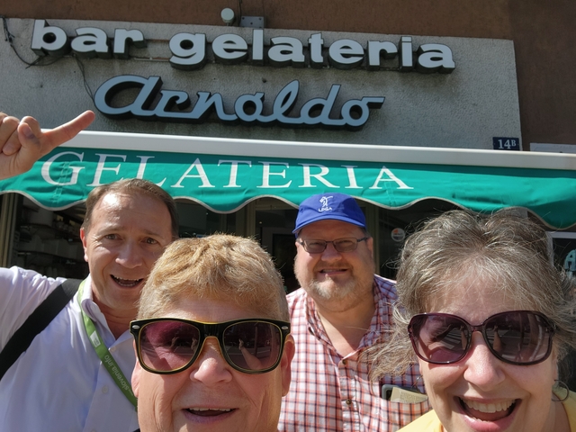 A group of people taking a selfie outside a gelateria.