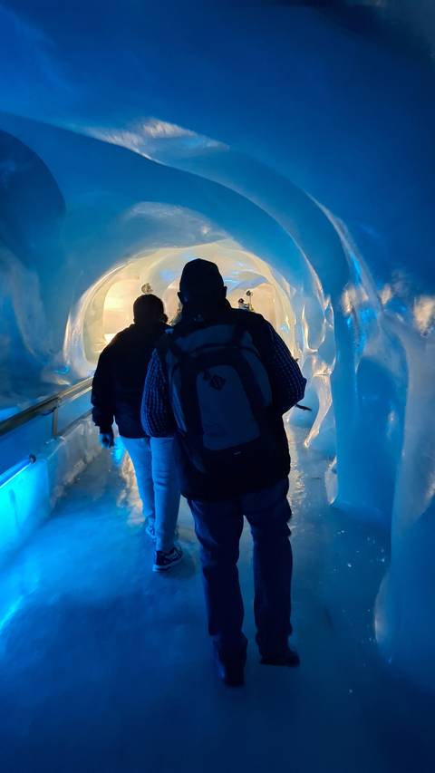 People walking inside an ice cave.