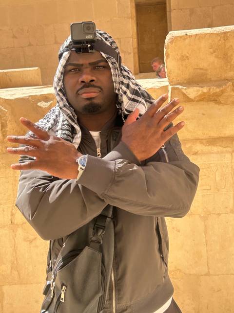       Person posing with crossed arms wearing a GoPro.
  