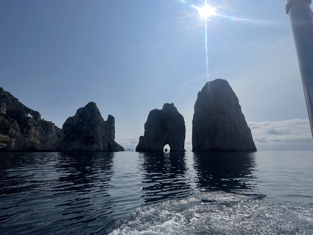 Faraglioni rock formations at sea.