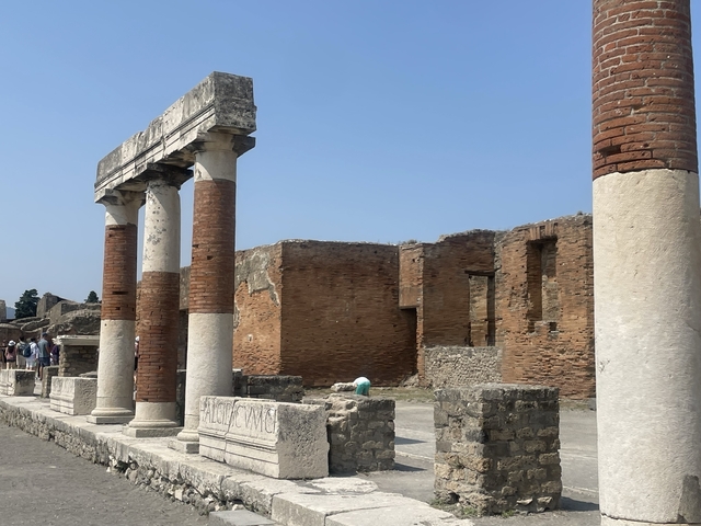 Roman ruins with standing columns in Pompeii.