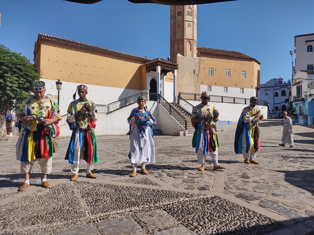 Five men in traditional Moroccan attire.