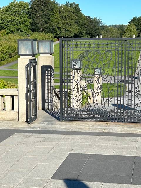       Artistic iron gate with pattern in a park.
  