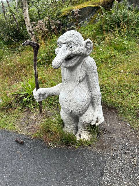       Decorative statue of an imaginative creature on grass.
  