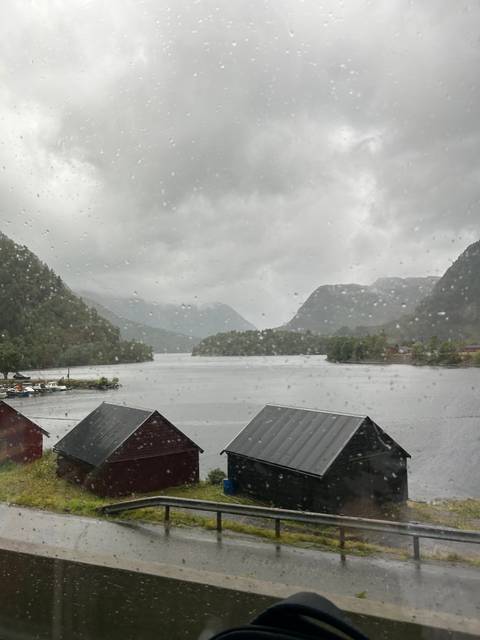       Rainy view of fjord with overcast skies.
  